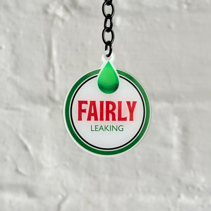 Funny “Fairly Leaking” acrylic keychain with oil drip design, glossy double-sided print and black chain, ideal for project cars and unreliable builds.