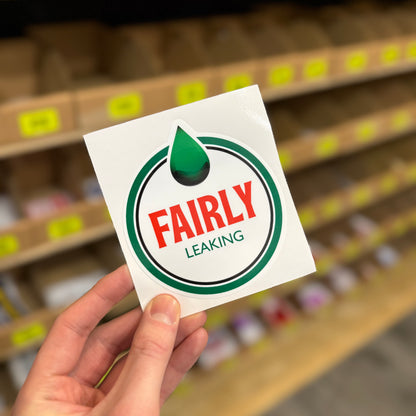 Funny car parody sticker reading “fairly leaking” oil warning style design