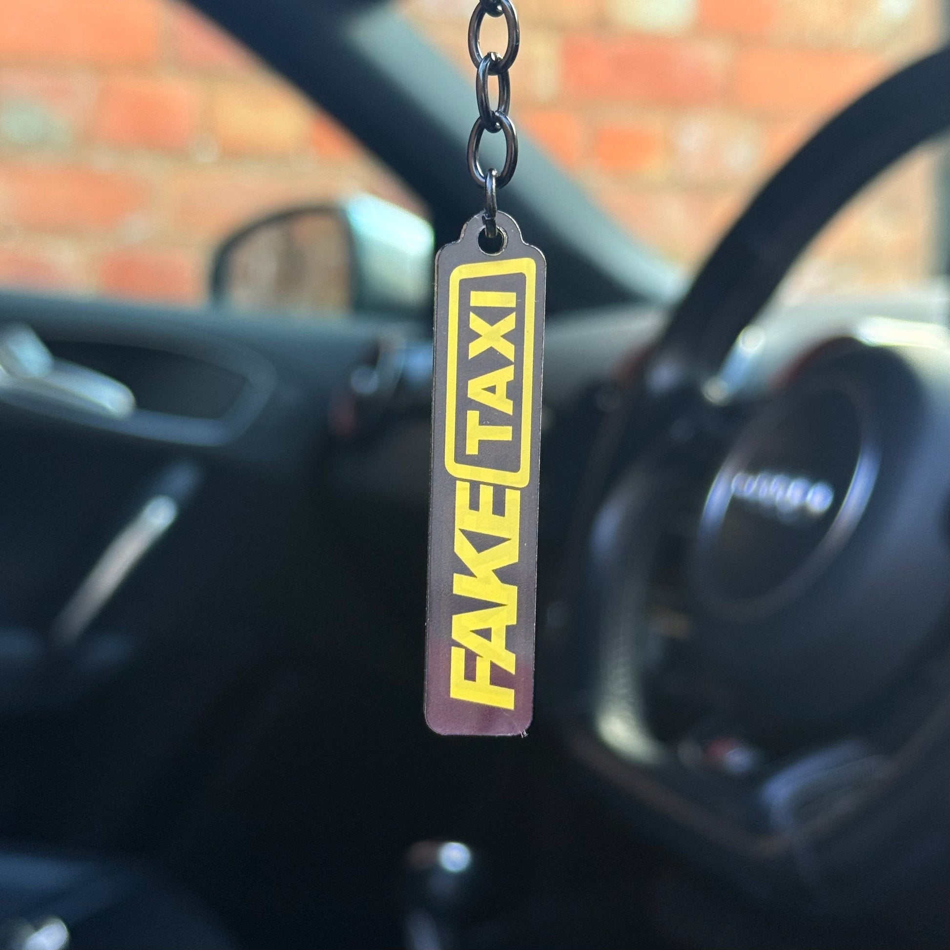 Funny “Fake Taxi” keychain with bold yellow and black design, novelty automotive keyring for car enthusiasts, durable acrylic accessory UK