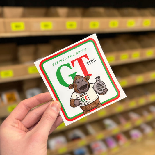 Funny car sticker parody reading “GT tips” with cartoon bear holding turbo