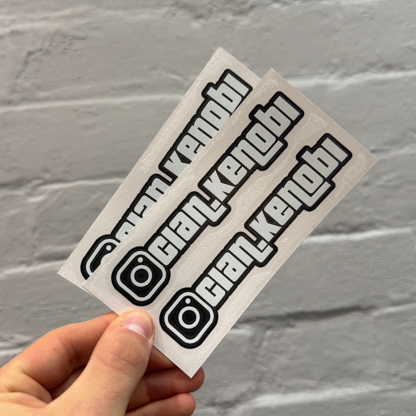 Custom gloss white Instagram handle stickers with black outline, personalised vinyl social media decals supplied as a pair for cars