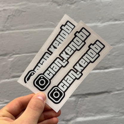 Custom gloss white Instagram handle stickers with black outline, personalised vinyl social media decals supplied as a pair for cars
