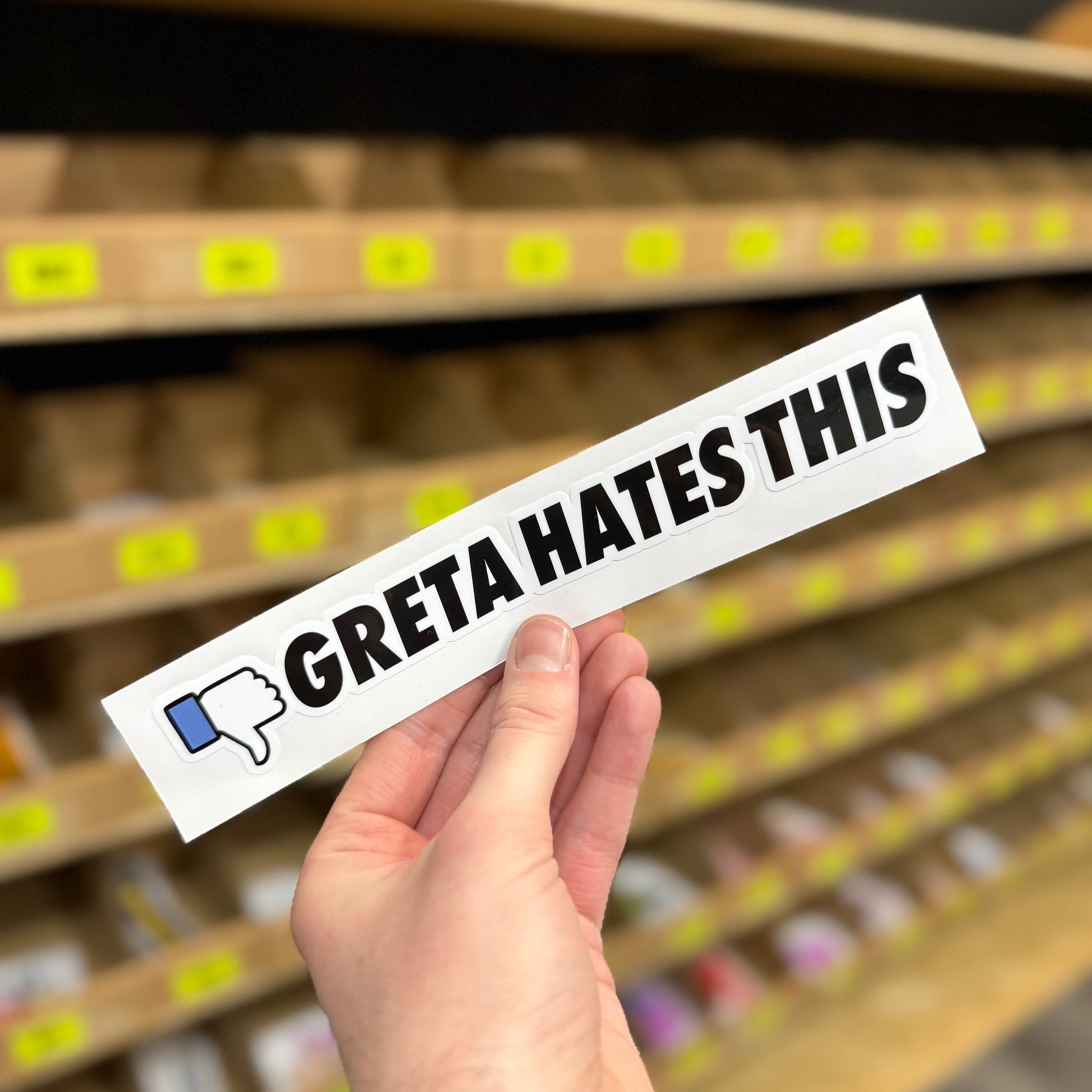 Funny car sticker reading “Greta hates this” with thumbs down icon
