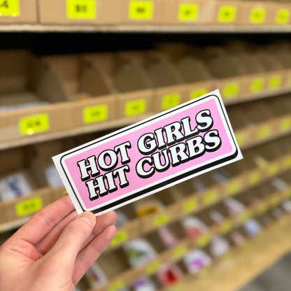 Funny car sticker reading “hot girls hit curbs” in pink and black novelty design