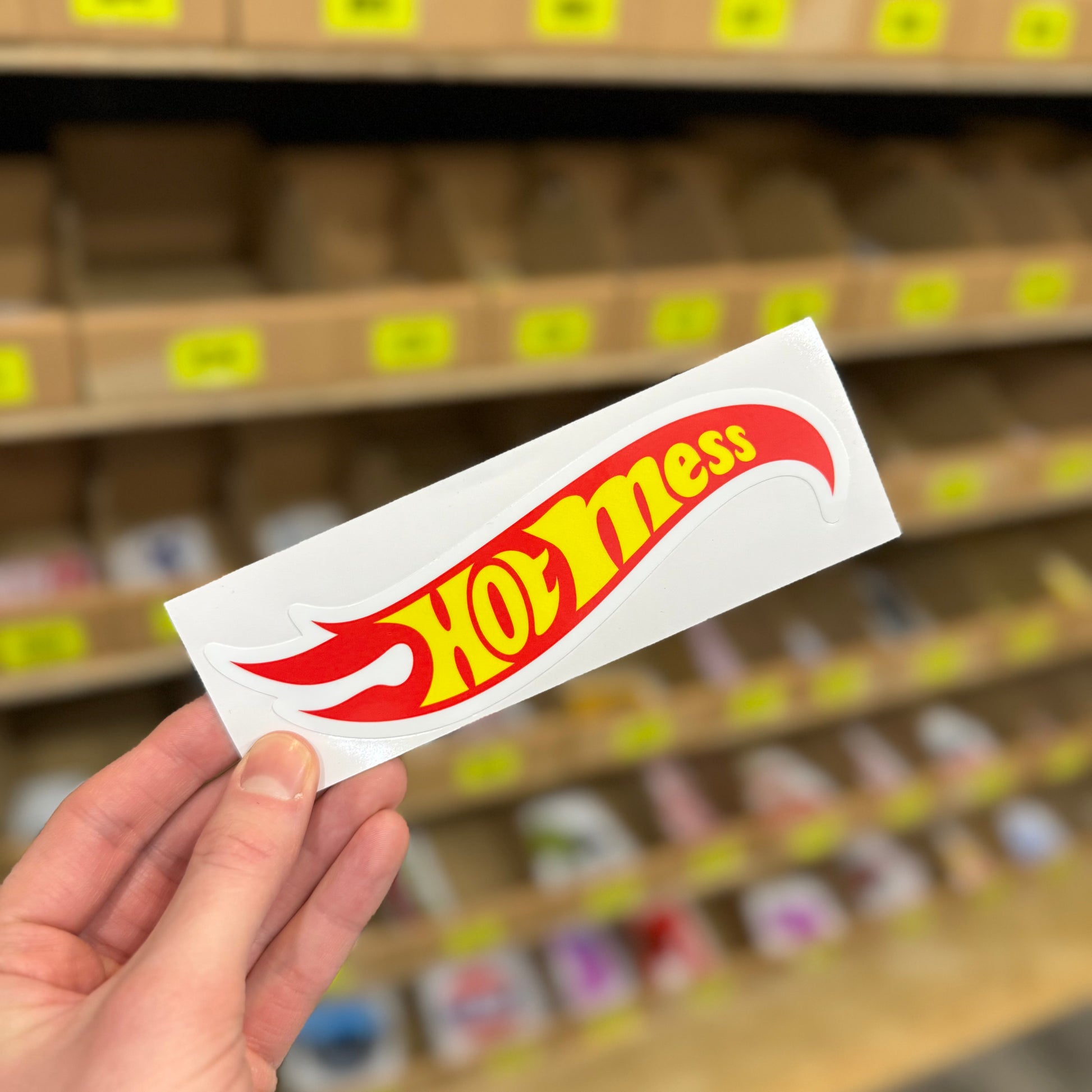 Funny parody sticker reading “hot mess” styled like flame logo graphic