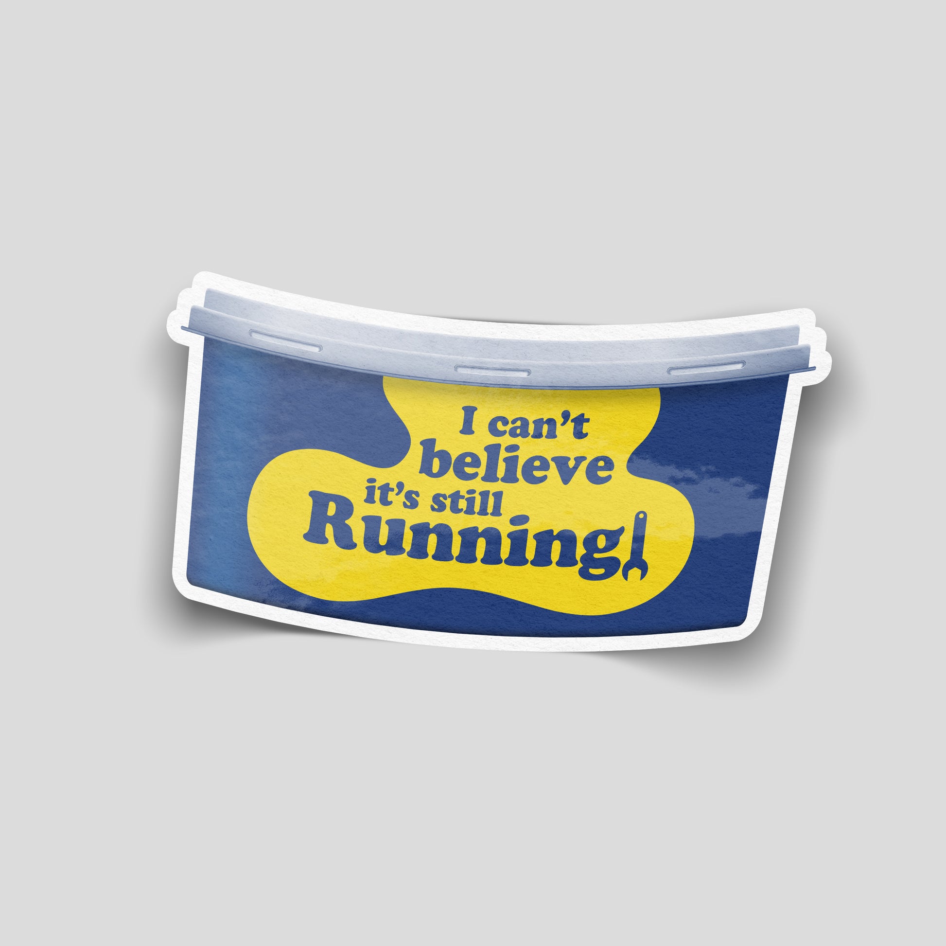 Funny car sticker styled like a yellow and blue tub label reading “I can’t believe it’s still running!”, UK motoring decal.