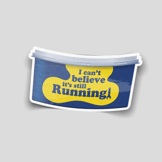 Funny car sticker styled like a yellow and blue tub label reading “I can’t believe it’s still running!”, UK motoring decal.