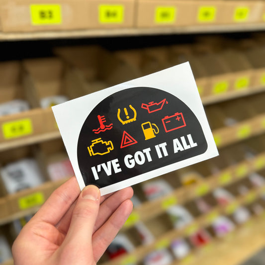 Funny car dashboard warning sticker reading “I’ve got it all” with warning icons