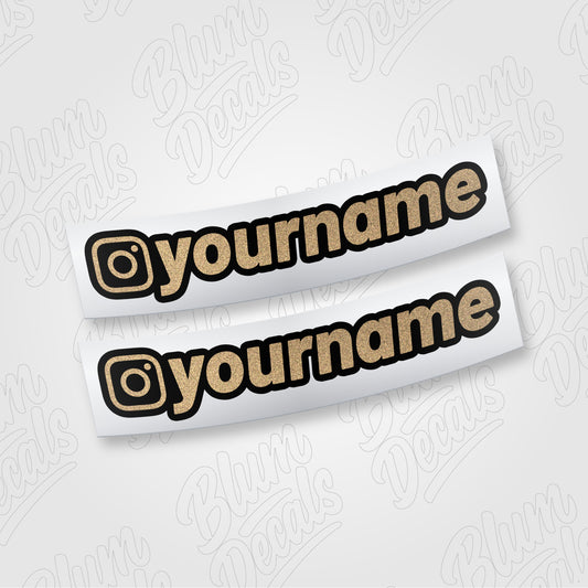 Custom Instagram username vinyl decal in gold glitter with a black outline, shown in font 19
