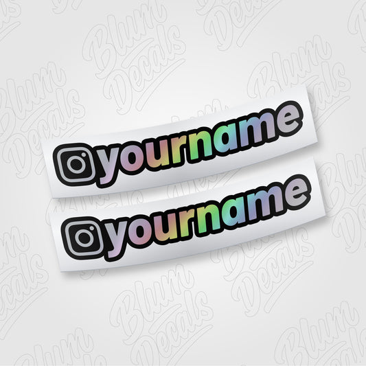 Custom Instagram username vinyl decal in silver holographic with a black outline, shown in font 19