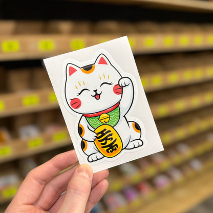 Funny Japanese lucky cat sticker holding coin with smiling cartoon design