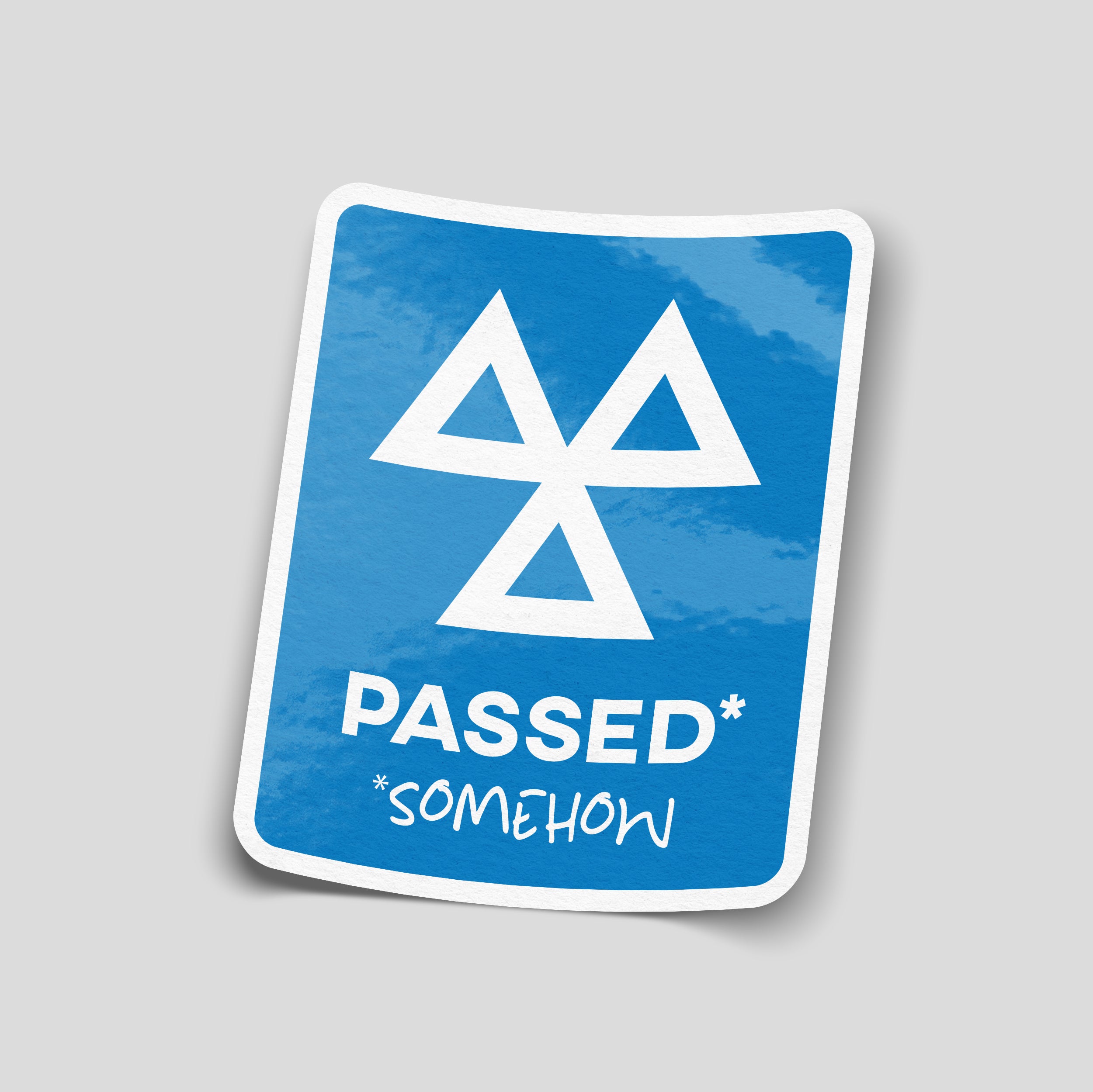 Blue MOT-inspired car sticker with a white three-triangle symbol and the wording “PASSED* *SOMEHOW”.