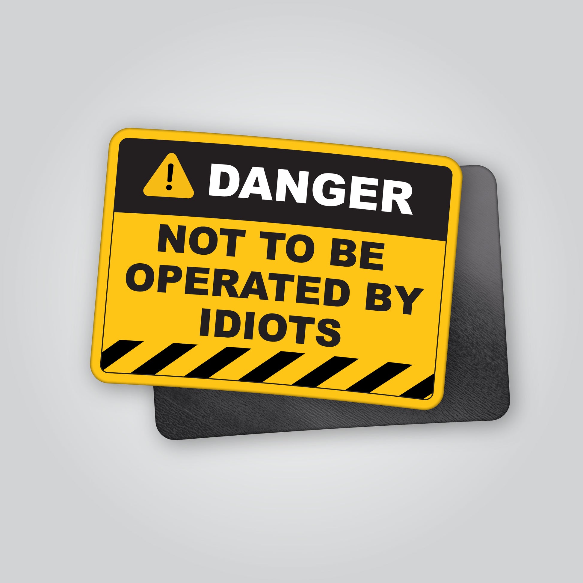 Funny “Danger – Not To Be Operated By Idiots” magnet styled like an industrial hazard warning sign. Humorous novelty magnet ideal for garages, toolboxes, vans or workshops. Designed and made in the UK by Blum Decals.