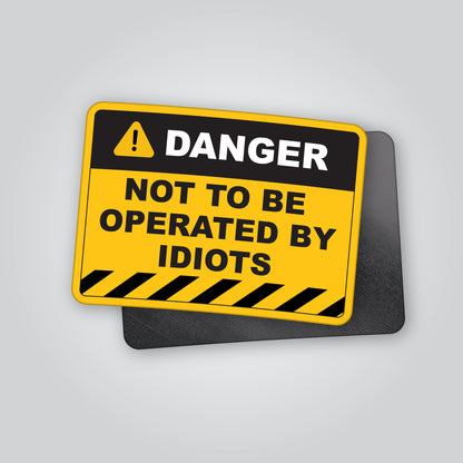 Funny “Danger – Not To Be Operated By Idiots” magnet styled like an industrial hazard warning sign. Humorous novelty magnet ideal for garages, toolboxes, vans or workshops. Designed and made in the UK by Blum Decals.