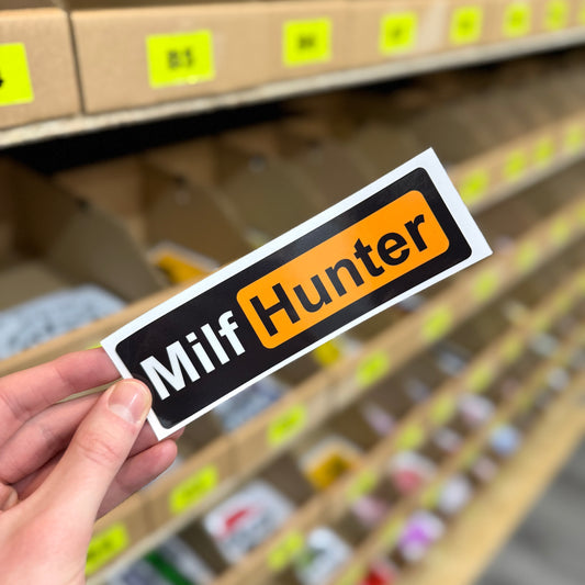 Funny novelty sticker reading “milf hunter” in bold black and orange text design