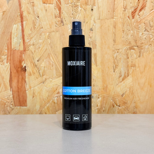 Moxiaire Cotton Breeze Premium Spray Air Freshener bottle on neutral background