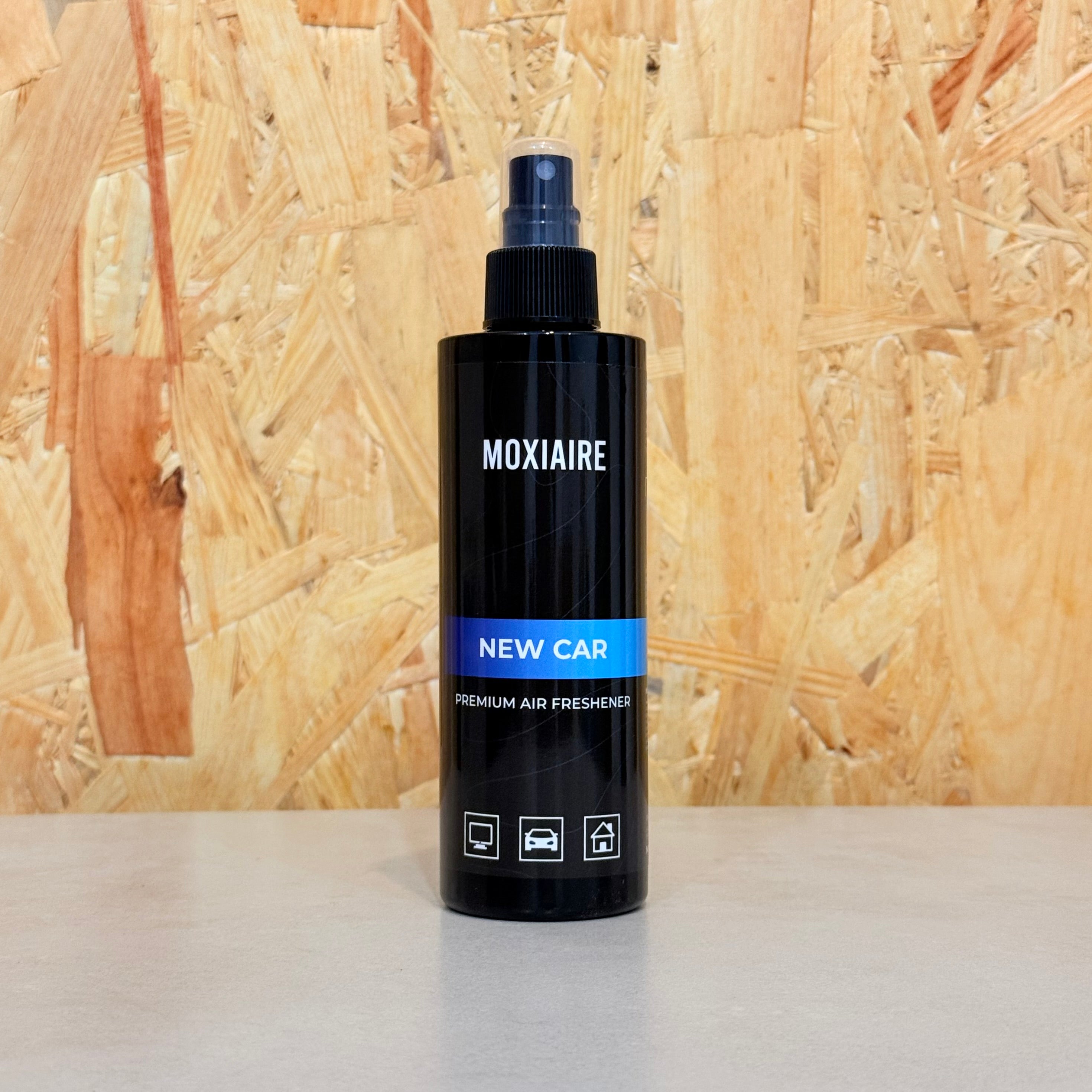 Moxiaire New Car Premium Spray Air Freshener bottle on neutral background