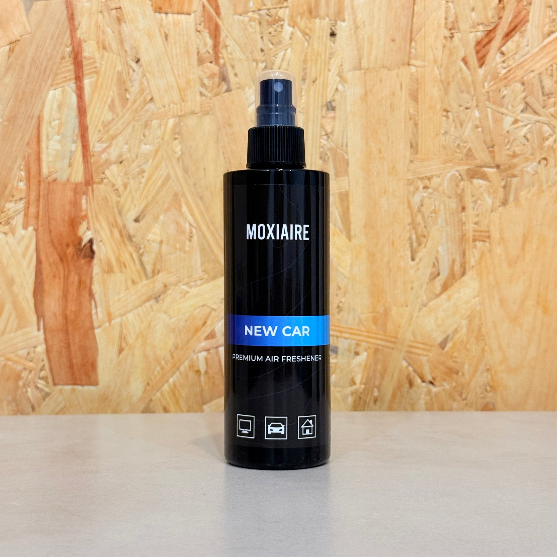 Moxiaire New Car Premium Spray Air Freshener bottle on neutral background