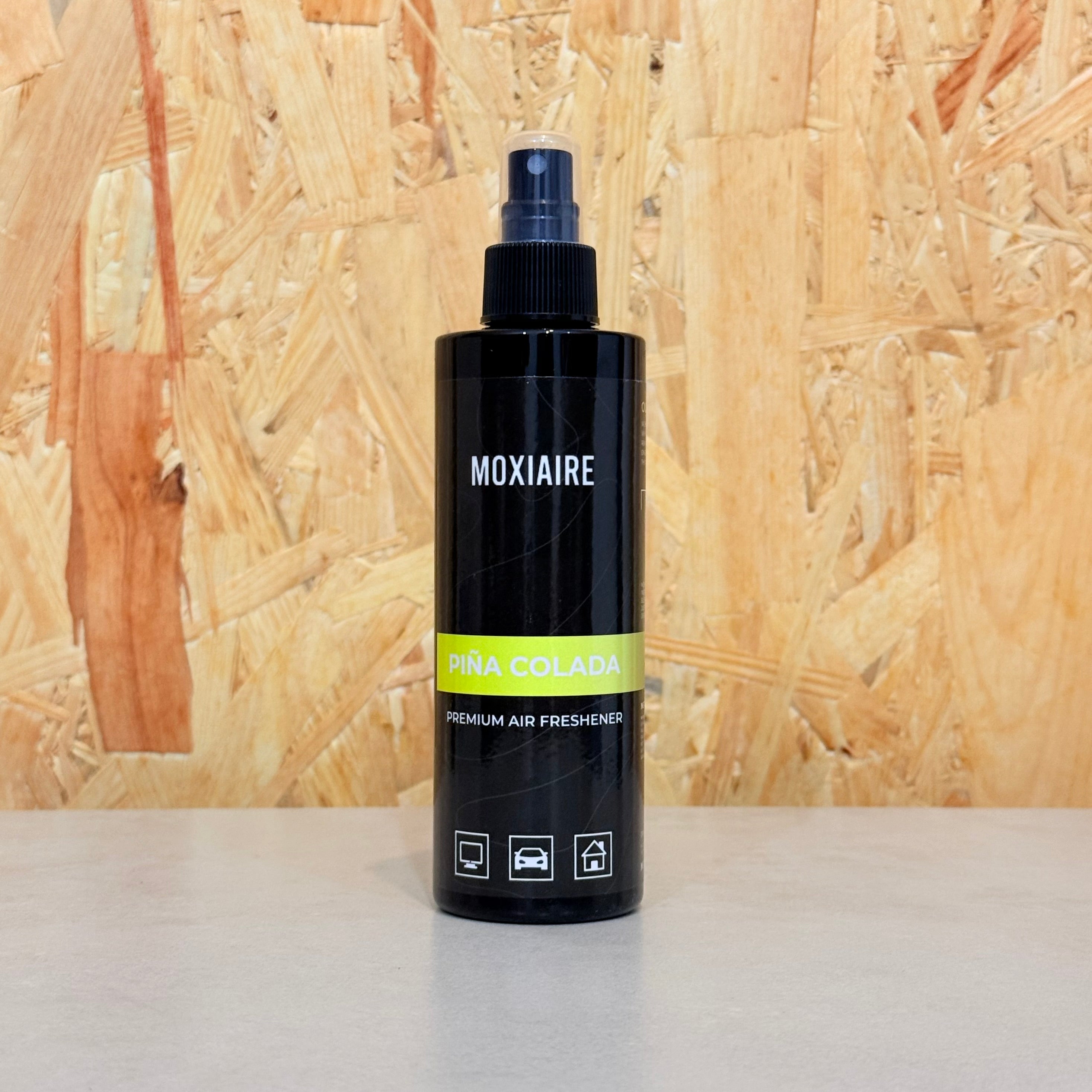 Moxiaire Pina Colada Premium Spray Air Freshener bottle on neutral background