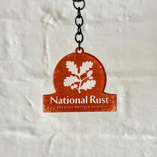 Funny “National Rust” acrylic keychain with distressed orange design, glossy finish and black chain, ideal for classic car lovers and rusty project builds.