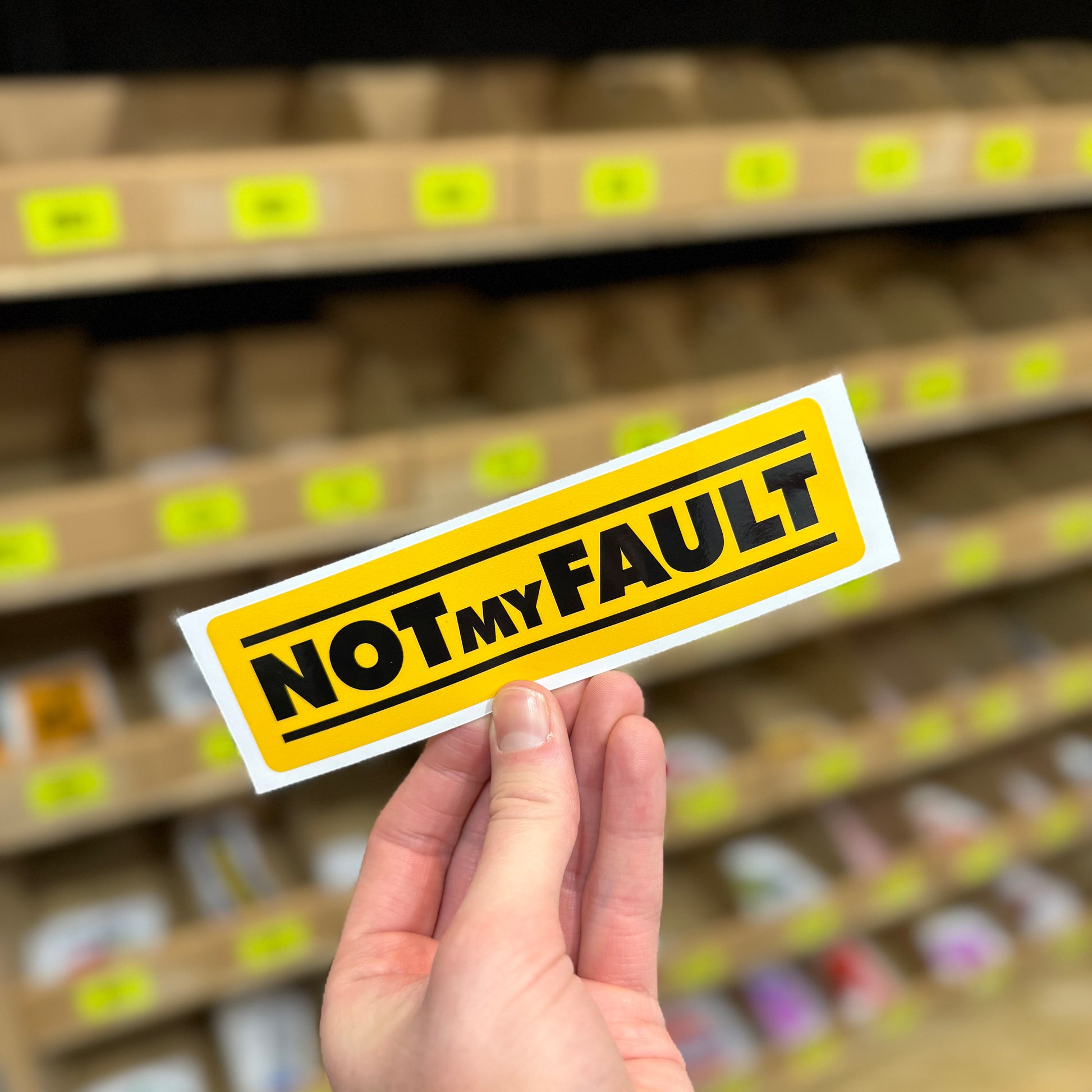 Funny warning sticker reading “not my fault” in bold yellow sign style