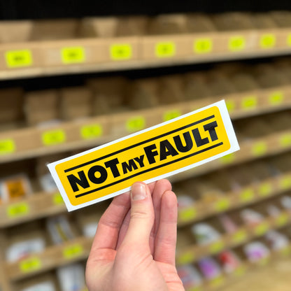 Funny warning sticker reading “not my fault” in bold yellow sign style