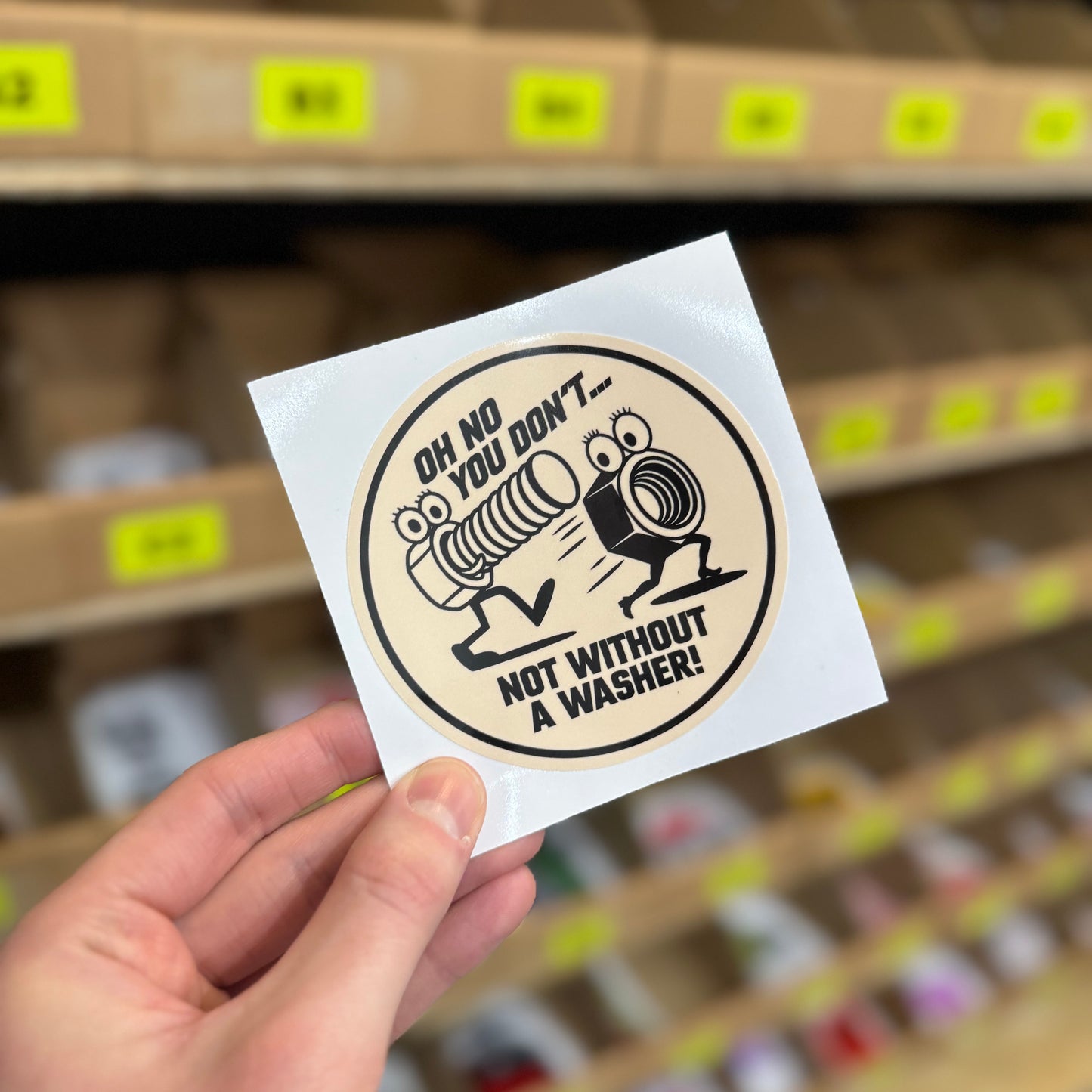 Funny mechanic sticker showing cartoon bolts with “not without a washer” text