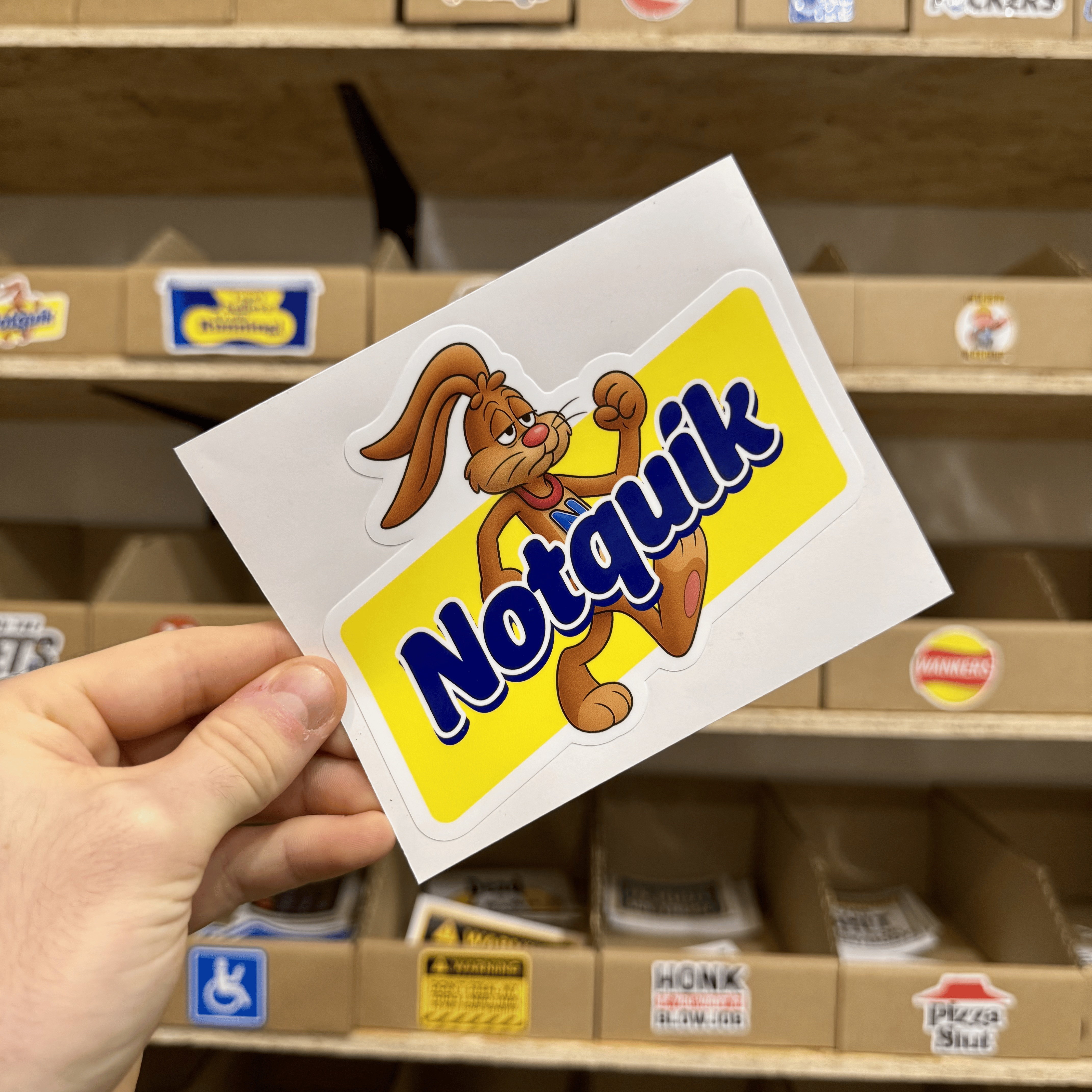 Parody yellow and blue sticker featuring a cartoon rabbit flexing next to the text ‘Notquik.