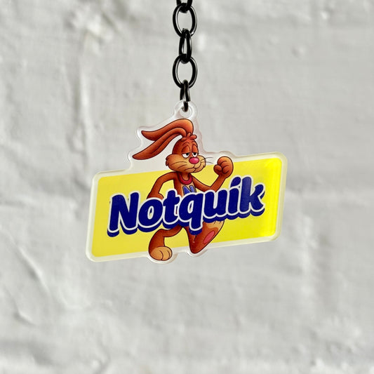 Funny “Notquik” acrylic keychain with cartoon rabbit design and yellow background, glossy double-sided print, perfect novelty car keyring gift.