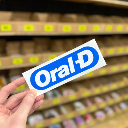 Funny toothpaste parody sticker reading “oral d” in blue and white logo style