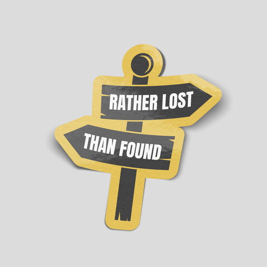Black signpost-shaped sticker with opposing arrows reading “Rather Lost Than Found”, white lettering and a mustard yellow border.