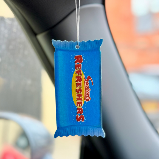 Swizzels Refreshers Car Air Freshener – Lemon Sherbet Scent hanging in a car. A fun and nostalgic air freshener bringing a sweet, zesty fragrance to your drive.