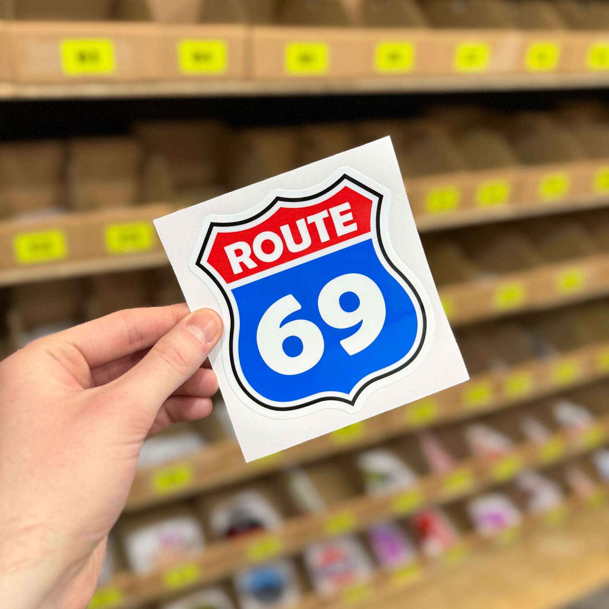 Funny road sign style sticker showing Route 69 highway shield design