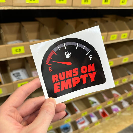 Funny car sticker showing fuel gauge on empty with “runs on empty” text