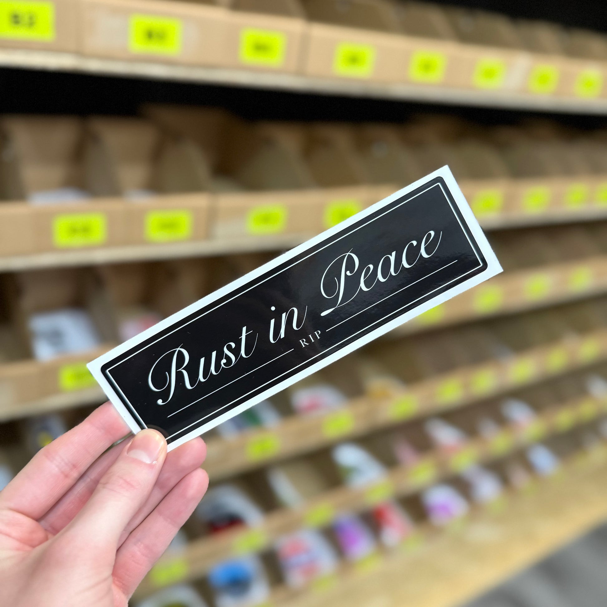 Black “Rust in Peace” funny car vinyl sticker with white script text