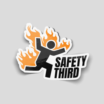 Funny safety third vinyl sticker featuring stick figure on fire, novelty worksite humour decal for workshops, garages and vans.