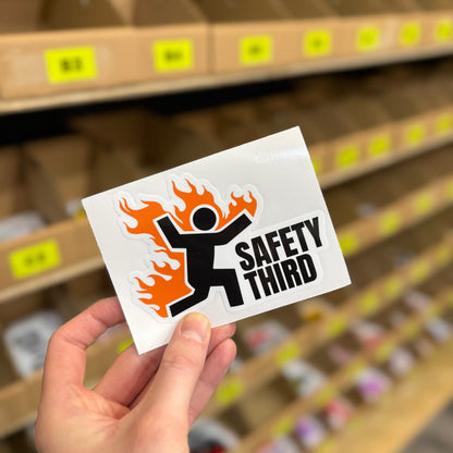 Flaming stick figure “Safety third” funny vinyl sticker with orange fire graphic.
