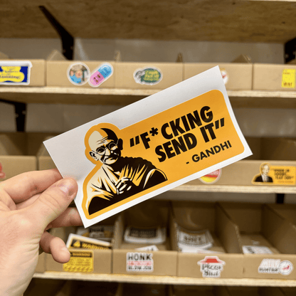Parody sticker with an illustrated figure resembling Gandhi and the quote ‘F*cking Send It.'