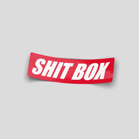 Shit box funny car sticker in bold white text on red, UK novelty car sticker by Blum Decals