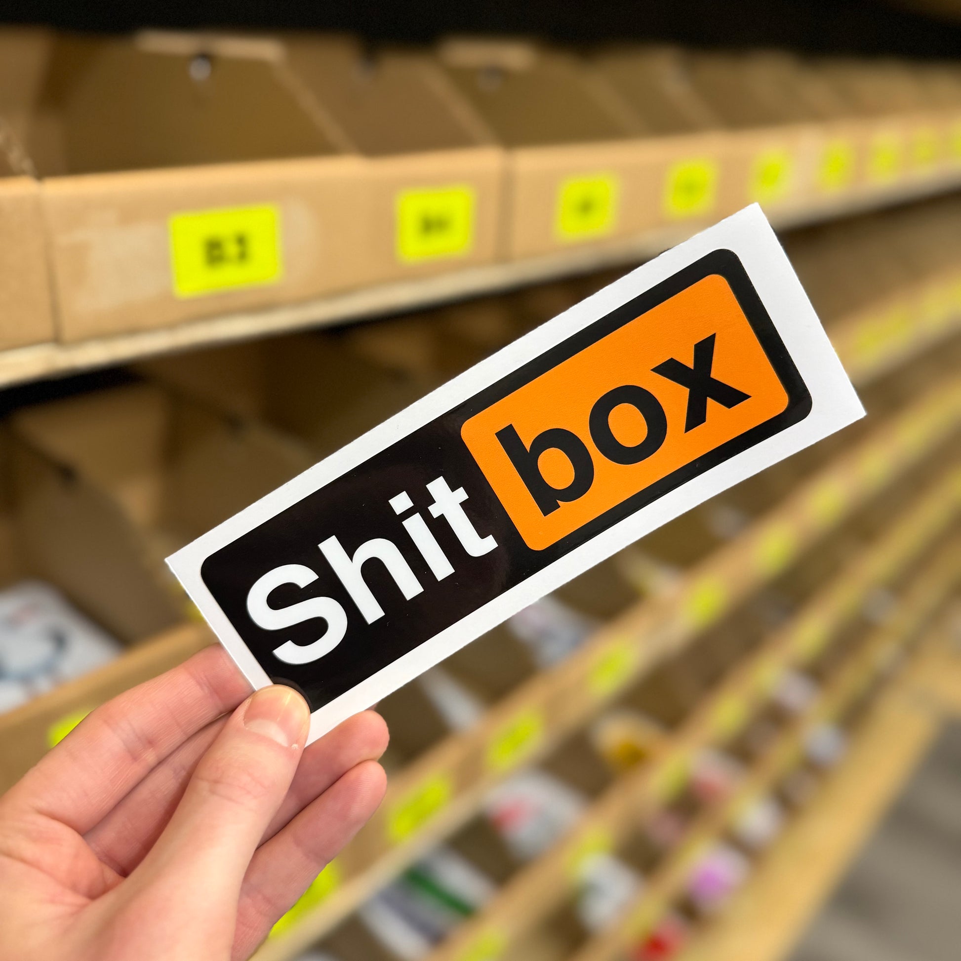 Shitbox parody funny vinyl sticker inspired by adult website logo in black and orange