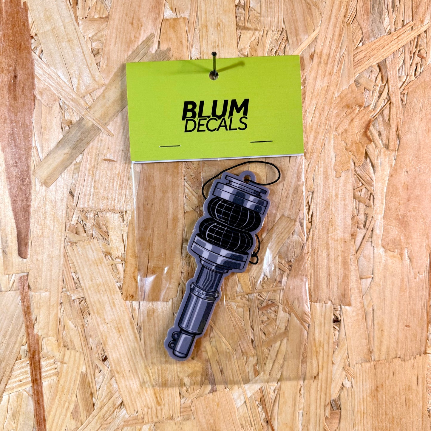 Keep your setup fresh with the Shock Absorber New Car Scent Air Freshener – clean, long-lasting, and full of automotive attitude.