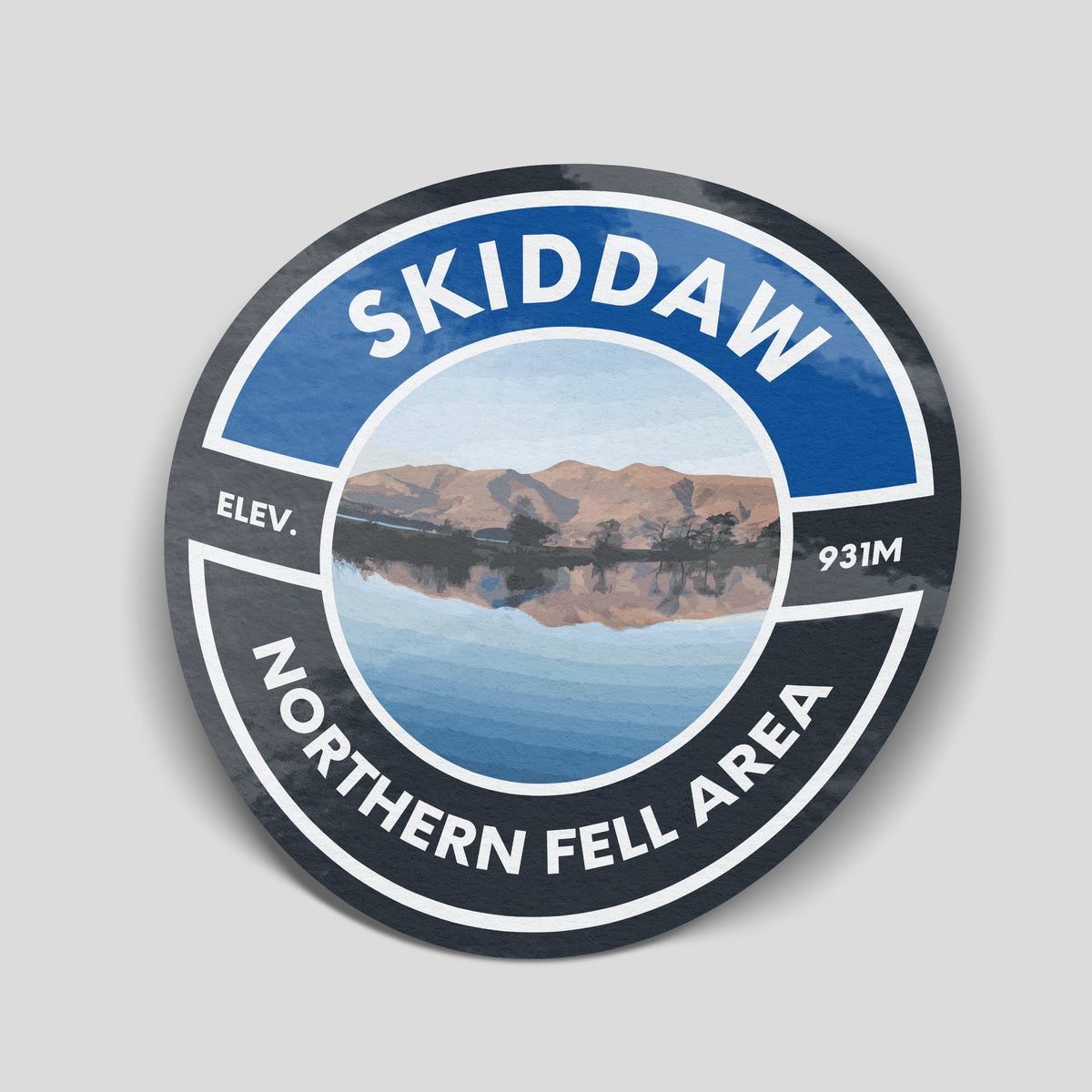 Deep blue and charcoal Skiddaw adventure sticker with mountains reflected in water, 931m elevation and Northern Fell Area lettering.