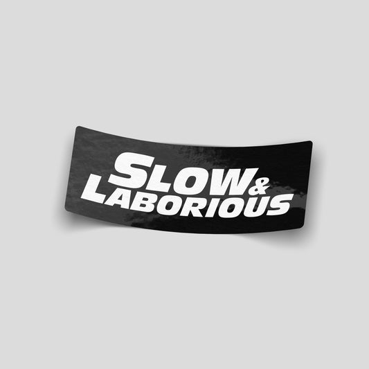 Slow and laborious funny car sticker in bold white text on black, UK automotive humour vinyl by Blum Decals