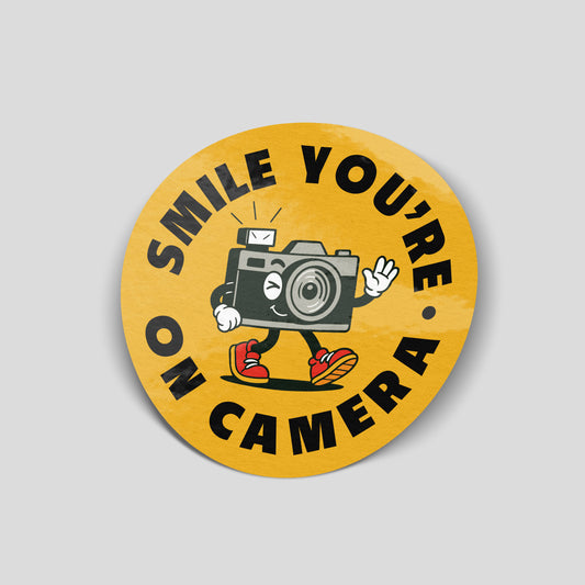 Smile You're On Camera funny vinyl sticker featuring a cartoon camera character, waterproof photography sticker for cars, laptops, camera cases and toolboxes.