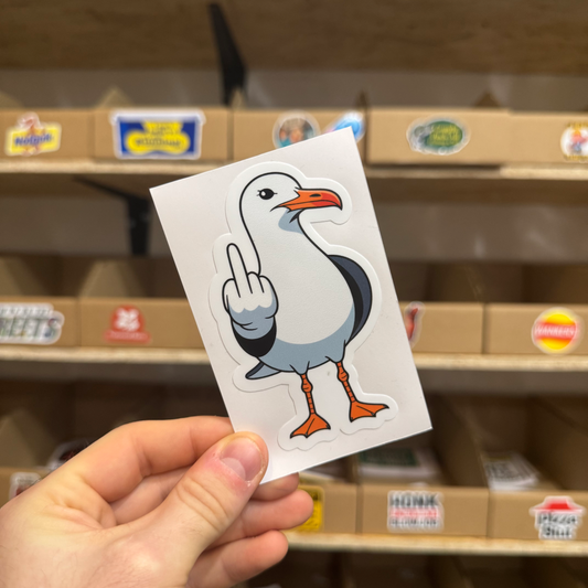 Funny cartoon seagull sticker showing the bird giving the middle finger.