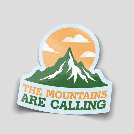 The Mountains Are Calling sticker with green snowy peaks, an orange sky, white clouds and orange and green lettering.