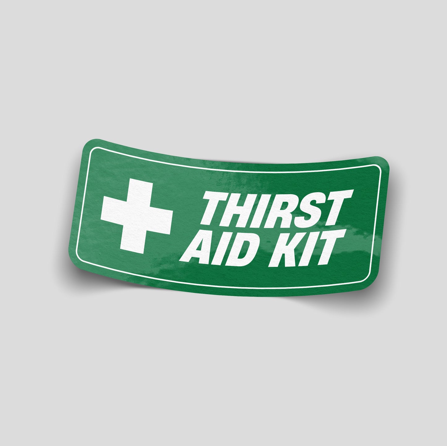 Green first‑aid sign parody reading “Thirst Aid Kit” with white medical cross, novelty funny car sticker for UK drivers.