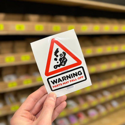 Triangular warning sign reading “Parts may fall off” funny vinyl sticker.